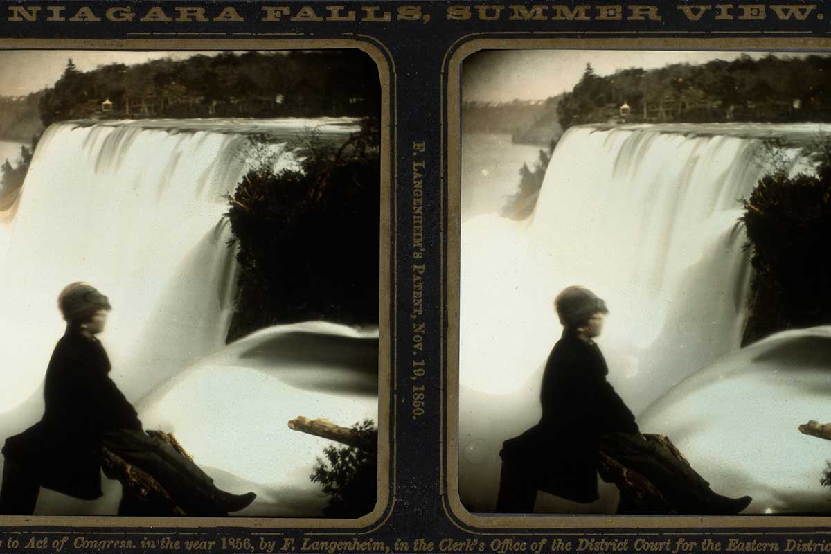 A stereoscopic image shows two views of a woman sitting by Niagara Falls.