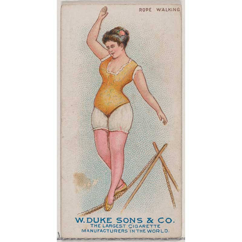 A female gymnast walks on a tightrope.