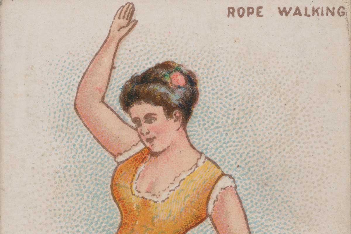 A female gymnast walks on a tightrope.
