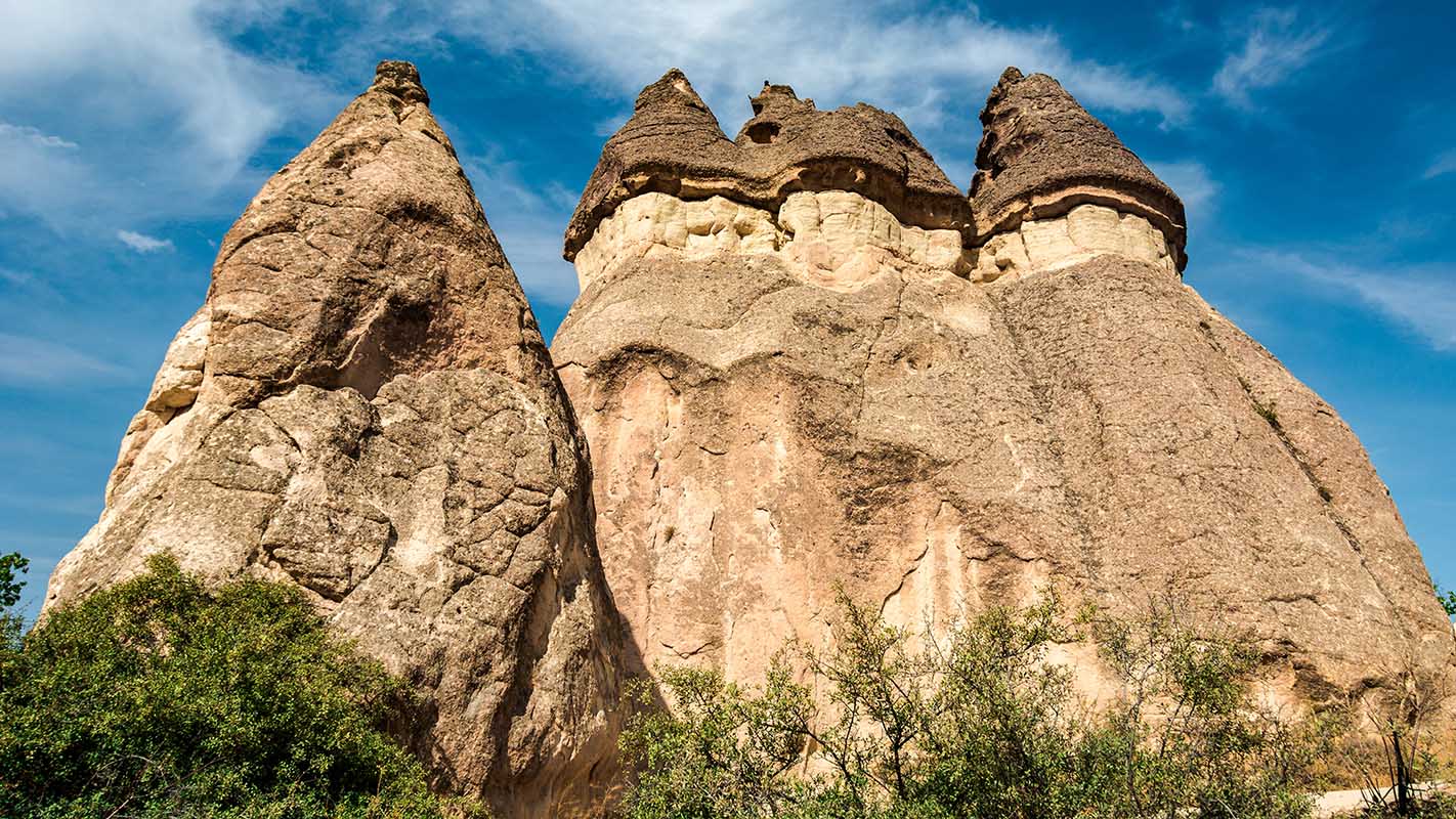 Rock formations called Fairy Chimneys rise up from the Valley of the Monks in Cappadocia, Turkey.