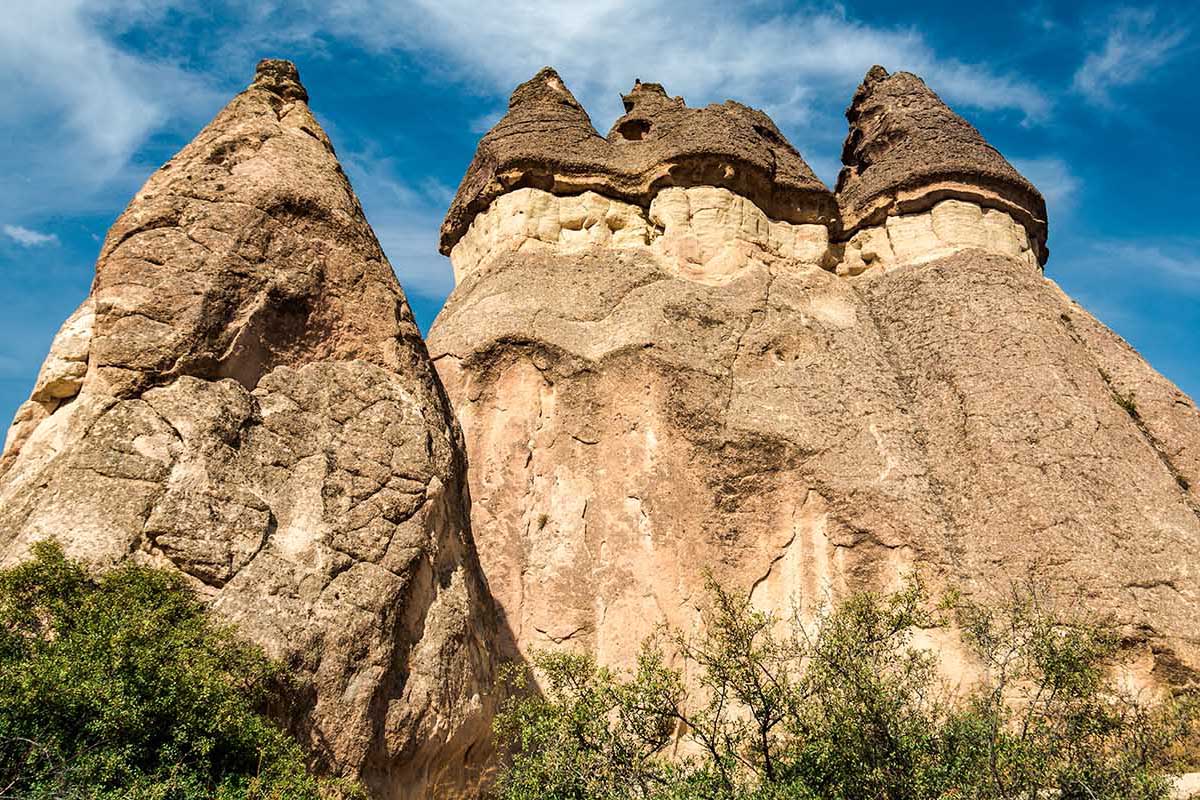 Rock formations called Fairy Chimneys rise up from the Valley of the Monks in Cappadocia, Turkey.